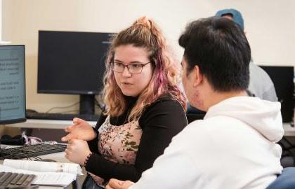 AU Student tutoring another student in the WCC